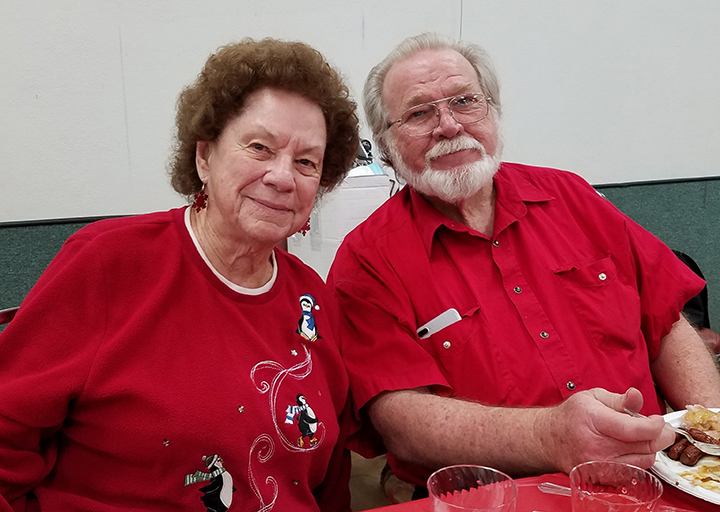 Gladys and Simon enjoying the Christmas Potluck in 2018